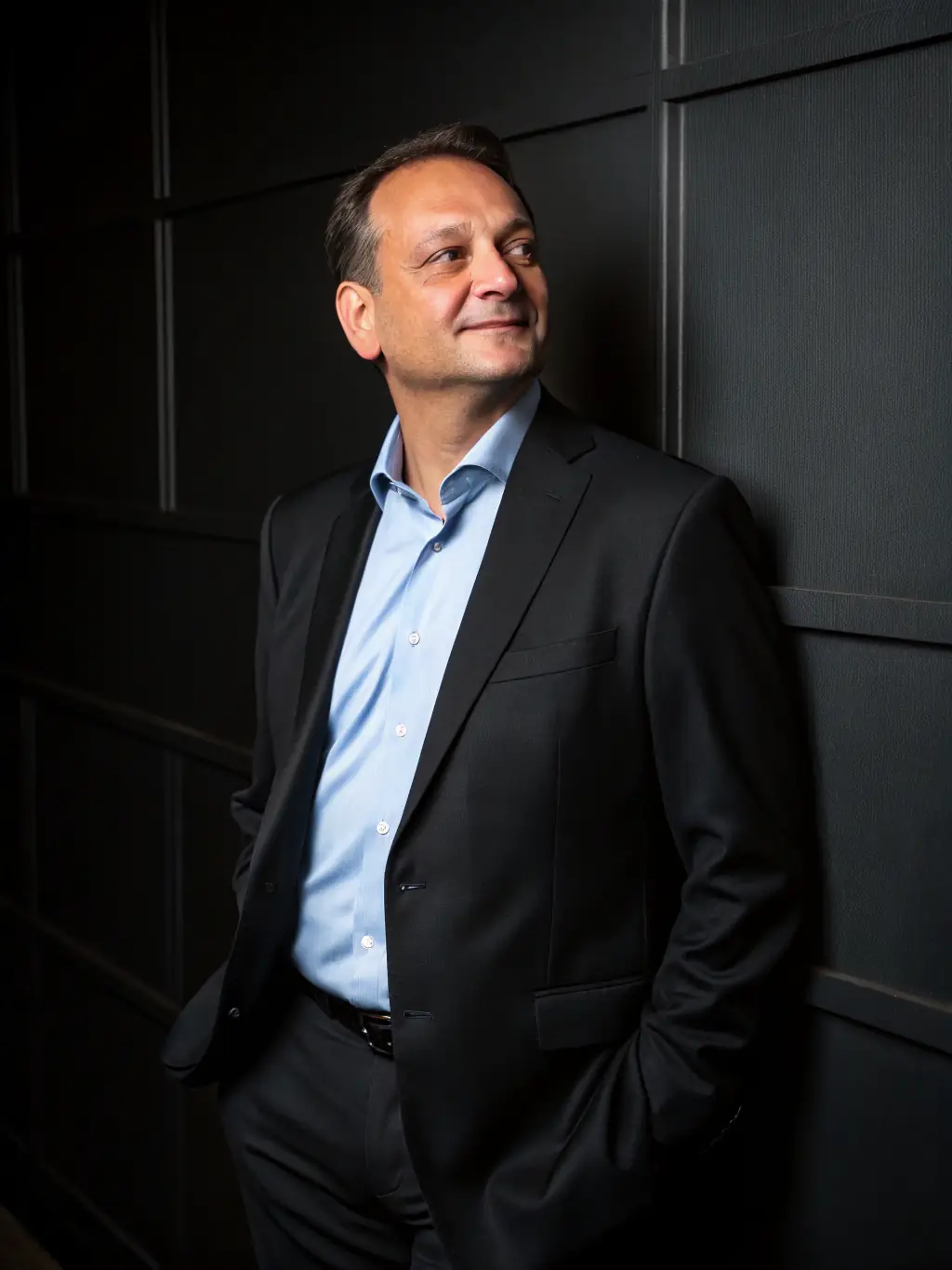 A professional headshot of a consultant smiling confidently, overlaid with the Launch Lead logo subtly in the corner, representing brand development services.